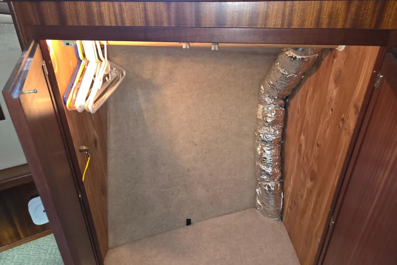 Slide: The Image of Empty closet with hangers and ductwork in 2012 American Tug 365 Flybridge. - 49