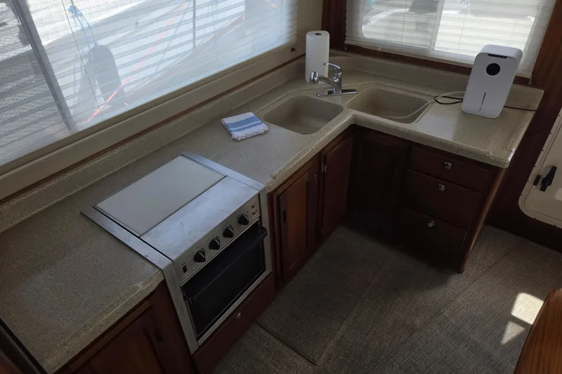 Slide: The Image of 2012 American Tug 365 Flybridge kitchen with stove, sink, and ample counter space. - 5