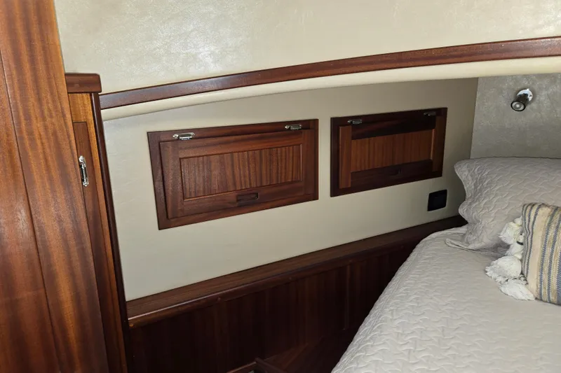 Slide: The Image of Cozy cabin interior of 2012 American Tug 365 Flybridge with wooden accents and bedding. - 50