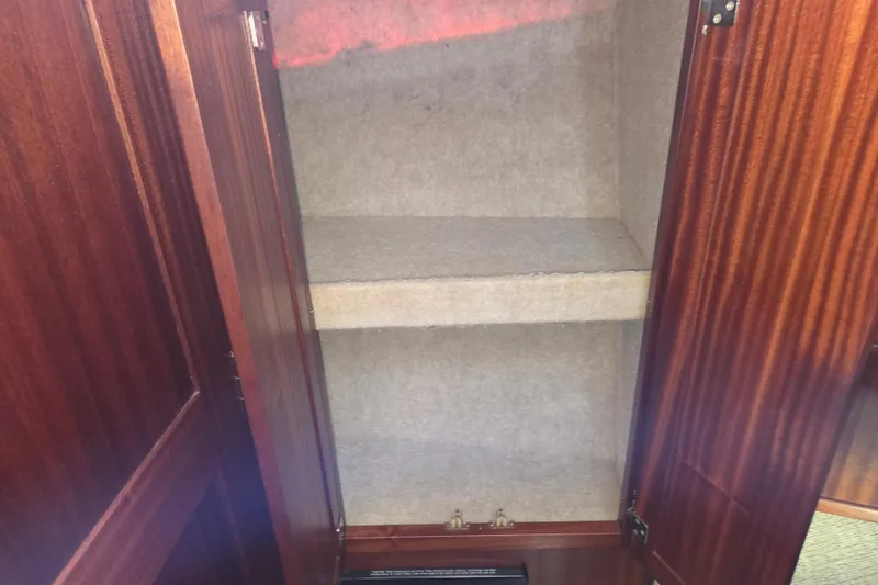 Slide: The Image of Empty wooden cabinet interior on 2012 American Tug 365 Flybridge boat. - 52
