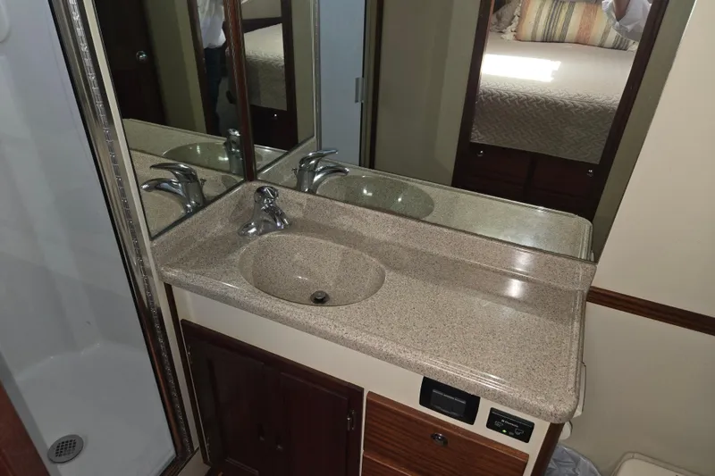 Slide: The Image of 2012 American Tug 365 Flybridge bathroom with sink, mirror, and shower. - 54