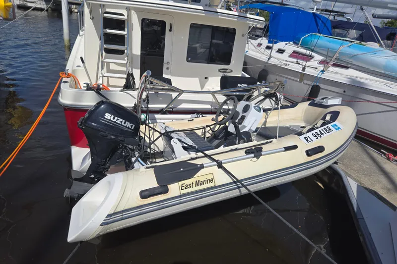 Slide: The Image of 2012 American Tug 365 Flybridge with Suzuki outboard motor at marina. - 62
