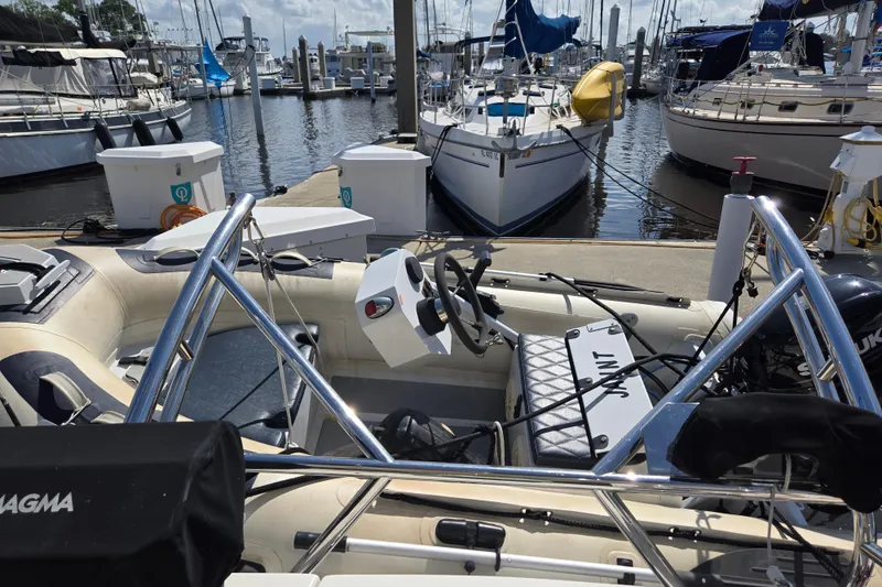 Slide: The Image of Docked boats at marina, featuring American Tug 365 Flybridge, 2012 model. - 63