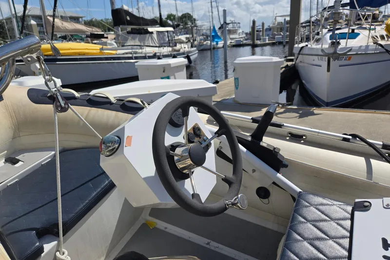 Slide: The Image of Steering wheel of a 2012 American Tug 365 Flybridge at a marina dock. - 64