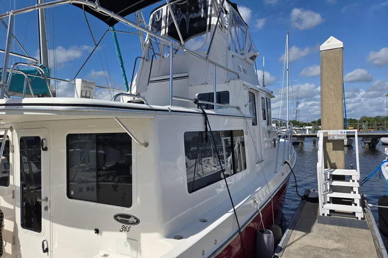 Slide: The Image of American Tug 365 Flybridge 2012 docked at marina under blue sky. - 67