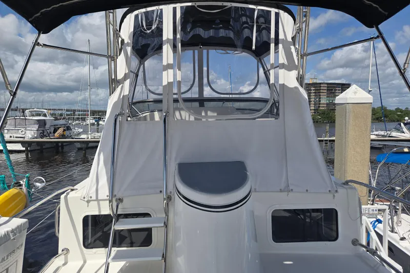 Slide: The Image of 2012 American Tug 365 Flybridge at marina, showcasing rear view and flybridge access. - 70