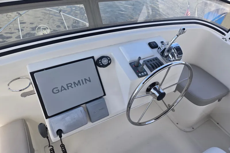 Slide: The Image of Helm of 2012 American Tug 365 Flybridge with Garmin navigation system and steering wheel. - 74