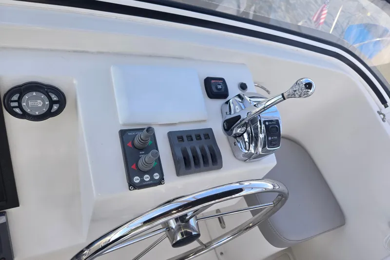 Slide: The Image of Control panel of a 2012 American Tug 365 Flybridge with steering wheel and throttle. - 76