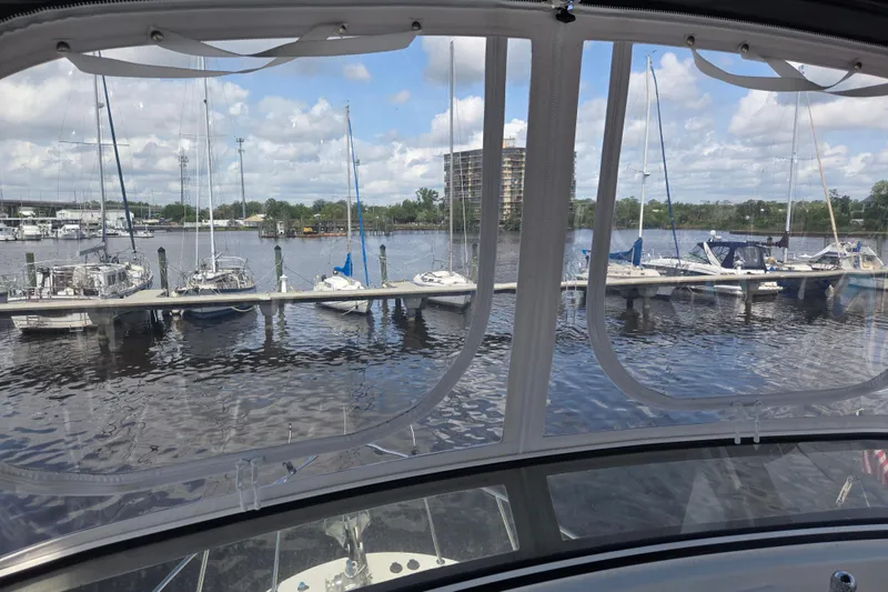 Slide: The Image of View from 2012 American Tug 365 Flybridge, overlooking marina with sailboats and clear skies. - 77