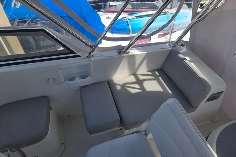 Slide: The Image of Interior seating area of 2012 American Tug 365 Flybridge with gray cushions and cup holders. - 80