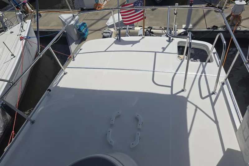 Slide: The Image of Flybridge of 2012 American Tug 365 with railing and American flag at dock. - 81