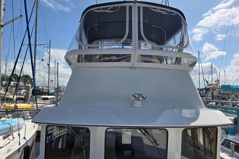 Slide: The Image of 2012 American Tug 365 Flybridge docked at marina under clear blue sky. - 90