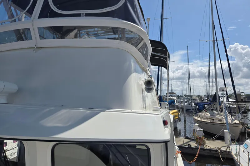 Slide: The Image of 2012 American Tug 365 Flybridge docked at marina under clear blue sky. - 91