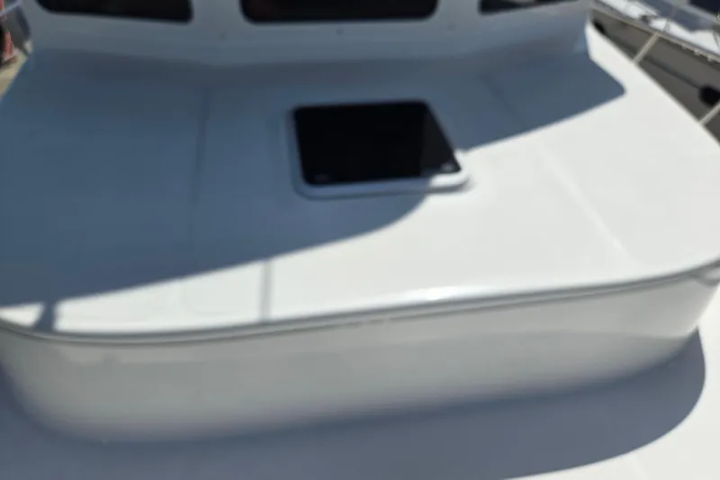 Slide: The Image of 2012 American Tug 365 Flybridge deck with hatch, showcasing sleek design. - 92