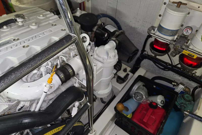 Slide: The Image of Engine room of a 2012 American Tug 365 Flybridge, featuring Cummins components and maintenance supplies. - 96