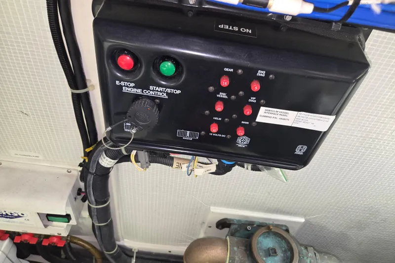 Slide: The Image of Engine control panel of 2012 American Tug 365 Flybridge with emergency stop and start buttons. - 99