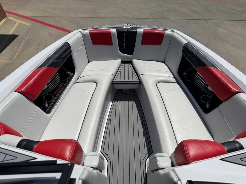 Slide: The Image of Interior of a 2014 Nautique G25 boat with red and black accents. - 10