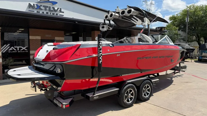 Slide: The Image of Red 2014 Nautique G25 boat at NXT LVL Marine. - 2