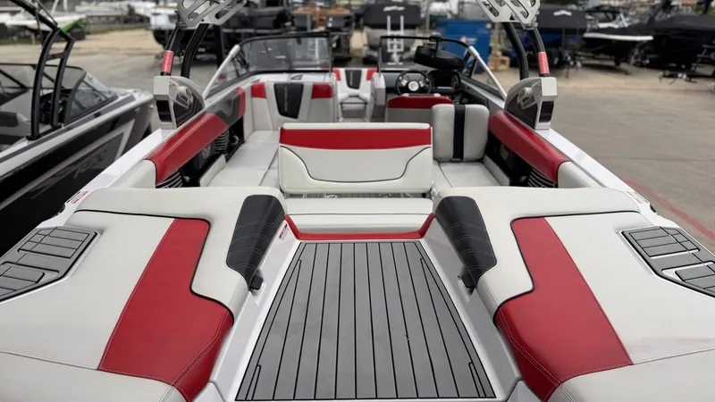 Slide: The Image of Interior of a 2014 Nautique G25 boat with red and white seating. - 20