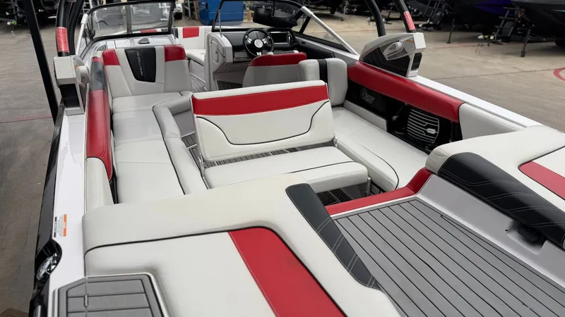 Slide: The Image of Interior of a 2014 Nautique G25 boat with red and white seating. - 21