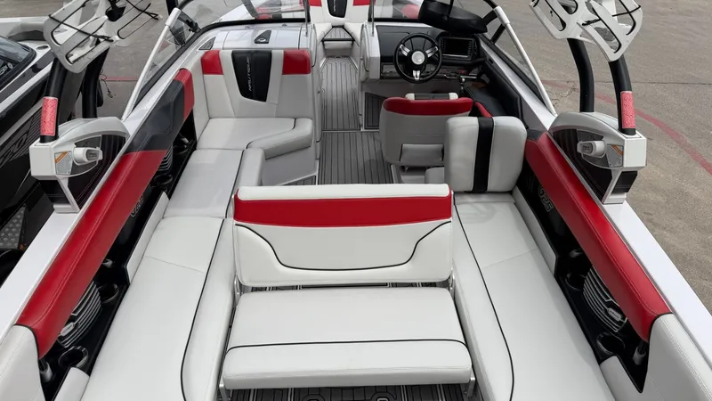 Slide: The Image of Interior of a 2014 Nautique G25 boat with red and white seating. - 22