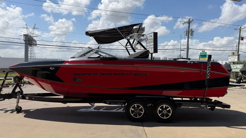 Slide: The Image of 2014 Nautique G25 boat on trailer, red and black, side view. - 7