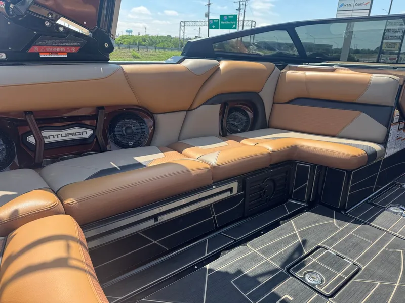 Slide: The Image of Interior of a 2023 Centurion Ri230 boat with brown leather seats. - 11