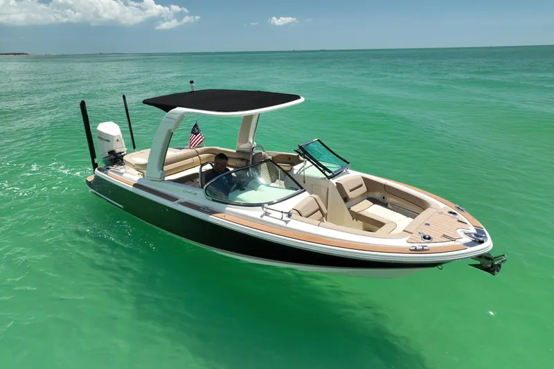 The Image of 2023 Chris-Craft Launch 25 GT boat on turquoise water, featuring sleek design and modern amenities. - 1