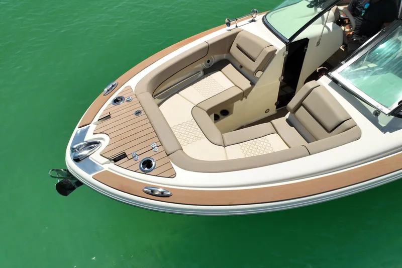 Slide: The Image of 2023 Chris-Craft Launch 25 GT boat with luxurious seating on turquoise water. - 10