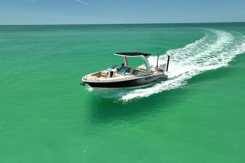 Slide: The Image of 2023 Chris-Craft Launch 25 GT cruising on vibrant turquoise waters. - 12