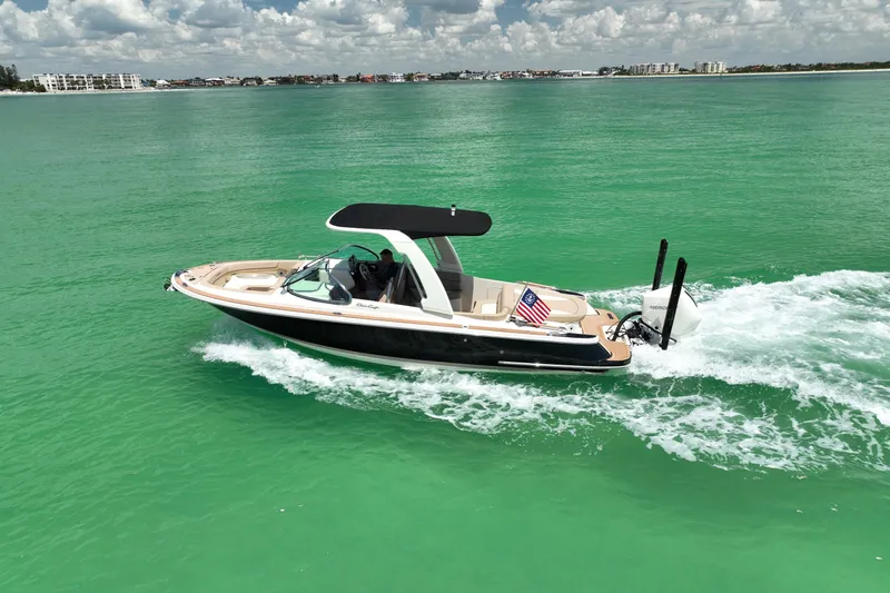 Slide: The Image of 2023 Chris-Craft Launch 25 GT cruising on vibrant turquoise waters. - 13