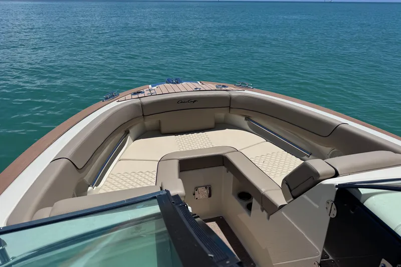 Slide: The Image of 2023 Chris-Craft Launch 25 GT boat interior with luxurious seating on calm water. - 15