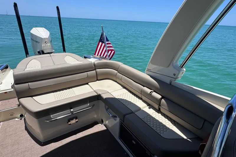 Slide: The Image of 2023 Chris-Craft Launch 25 GT boat interior with seating, ocean view, and American flag. - 17