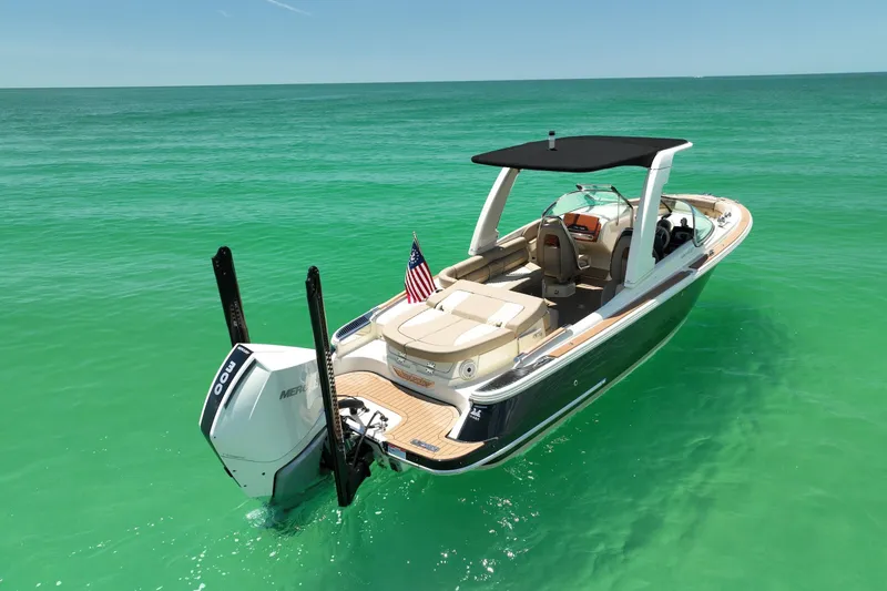 Slide: The Image of 2023 Chris-Craft Launch 25 GT boat on clear turquoise water, featuring a sleek design. - 2