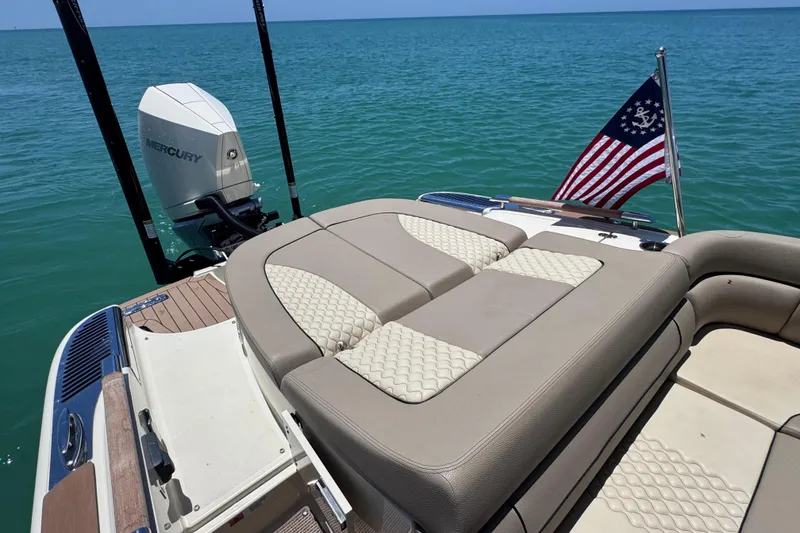 Slide: The Image of 2023 Chris-Craft Launch 25 GT boat with Mercury engine and American flag on open water. - 21