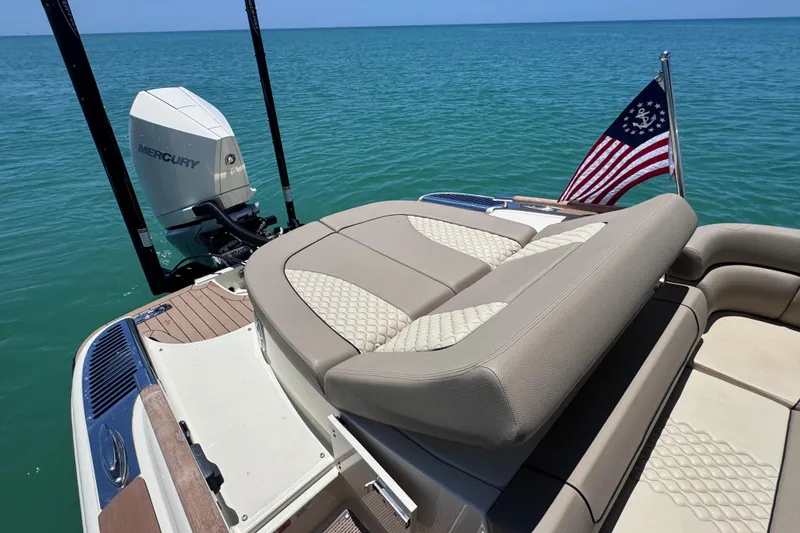 Slide: The Image of 2023 Chris-Craft Launch 25 GT boat with Mercury engine on calm blue water. - 22