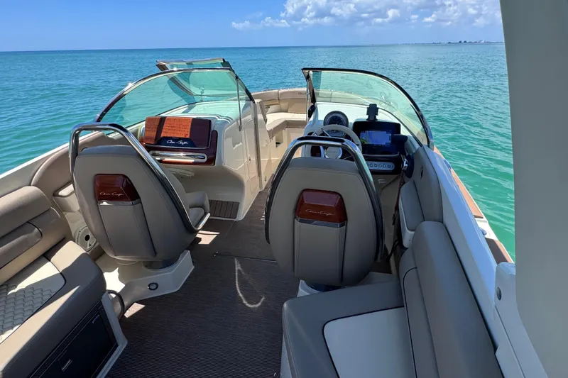 Slide: The Image of 2023 Chris-Craft Launch 25 GT interior with luxurious seating, dashboard, and ocean view. - 24
