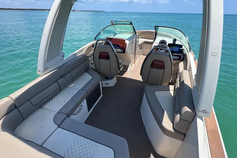 Slide: The Image of 2023 Chris-Craft Launch 25 GT boat interior with luxurious seating on open water. - 25