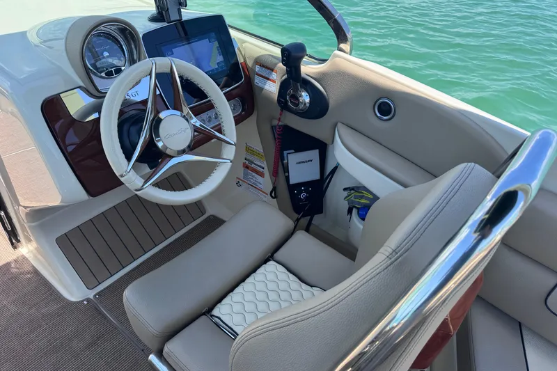 Slide: The Image of 2023 Chris-Craft Launch 25 GT cockpit with steering wheel and navigation display. - 28