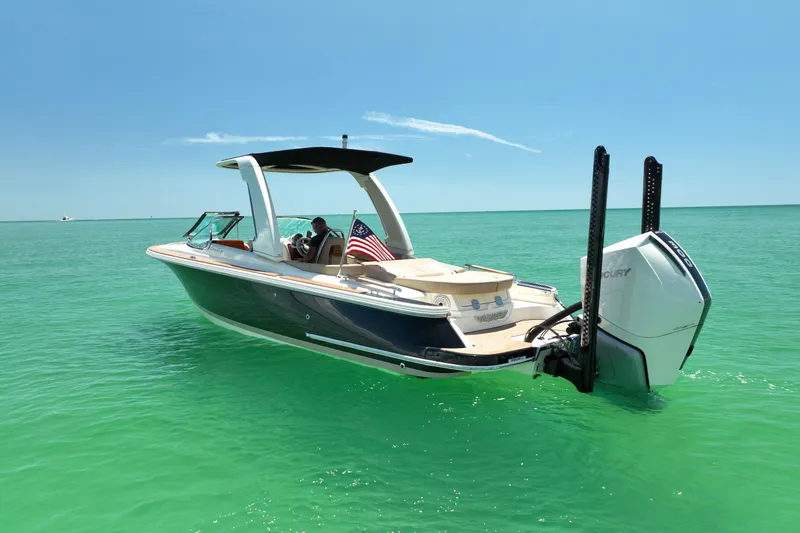 Slide: The Image of 2023 Chris-Craft Launch 25 GT boat on turquoise water, featuring sleek design and powerful engine. - 3