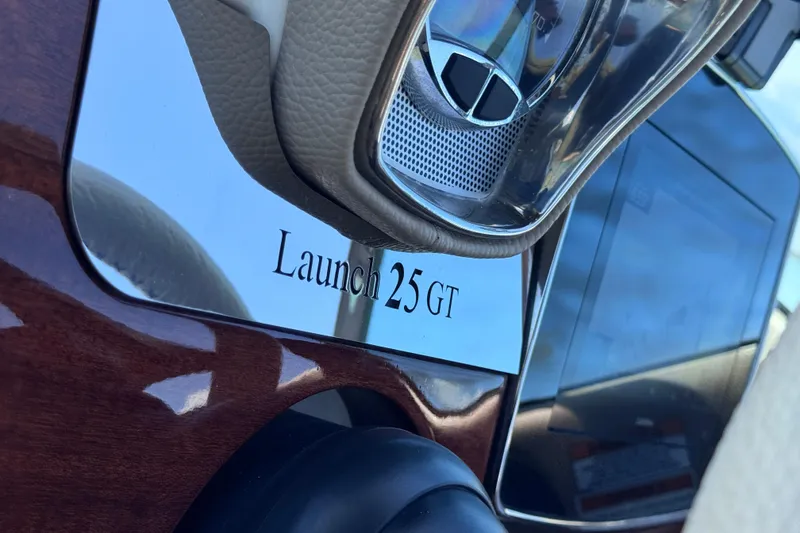 Slide: The Image of Close-up of 2023 Chris-Craft Launch 25 GT dashboard with elegant wood finish. - 34