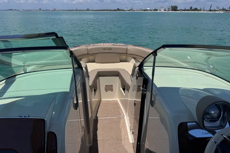 Slide: The Image of 2023 Chris-Craft Launch 25 GT boat interior with open deck and scenic water view. - 36