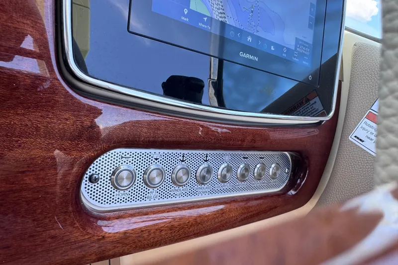 Slide: The Image of 2023 Chris-Craft Launch 25 GT dashboard with Garmin display and control buttons. - 38