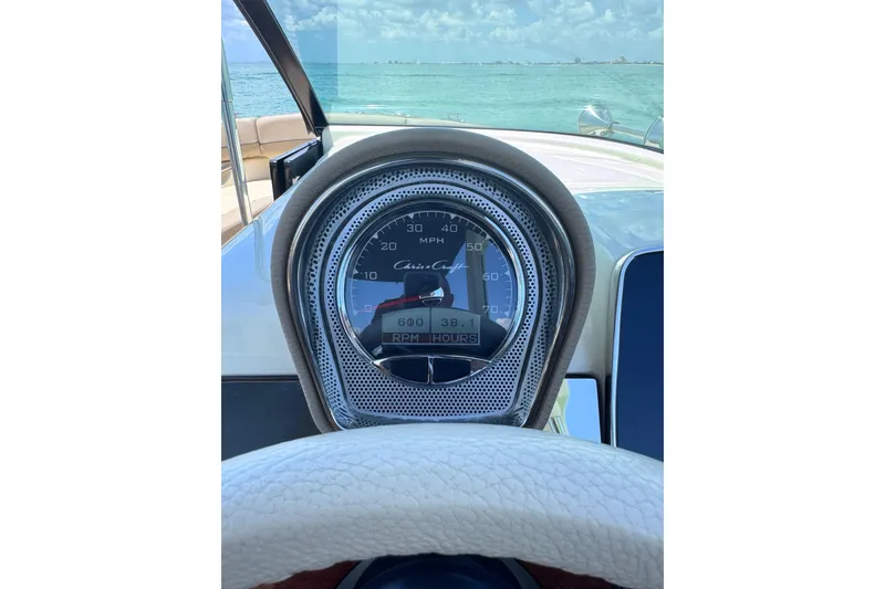 Slide: The Image of Dashboard view of 2023 Chris-Craft Launch 25 GT boat, showing speedometer and ocean backdrop. - 40