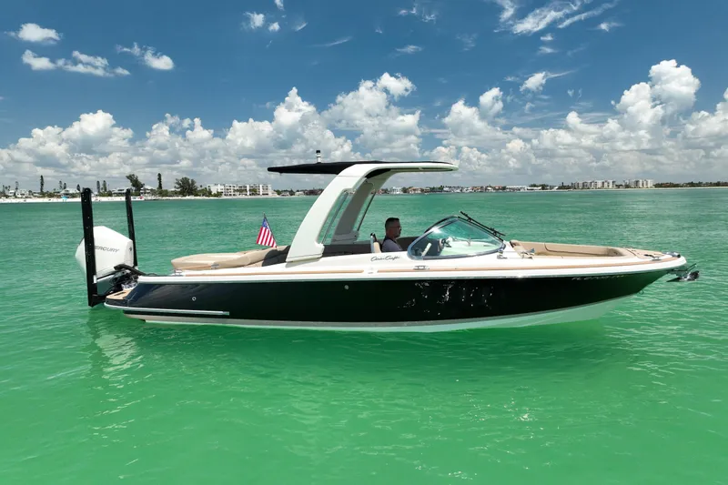 Slide: The Image of 2023 Chris-Craft Launch 25 GT boat on turquoise water under a blue sky. - 7