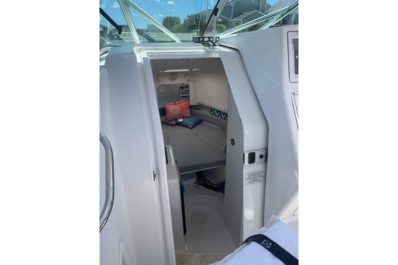 Slide: The Image of 2002 Pro-Line 260 Walkaround cabin interior with cushions and storage space. - 7