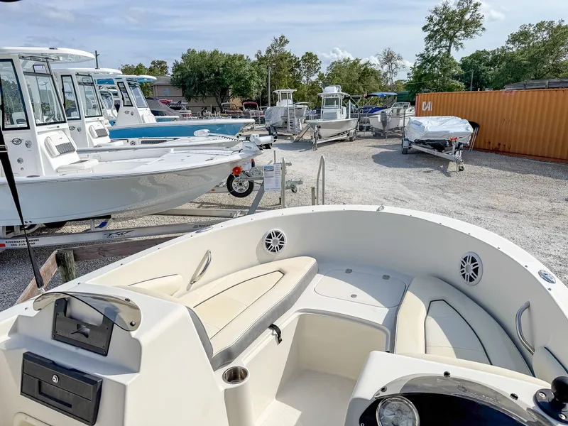 Slide: The Image of 2023 Stingray 172 SC boat parked in a marina. - 10