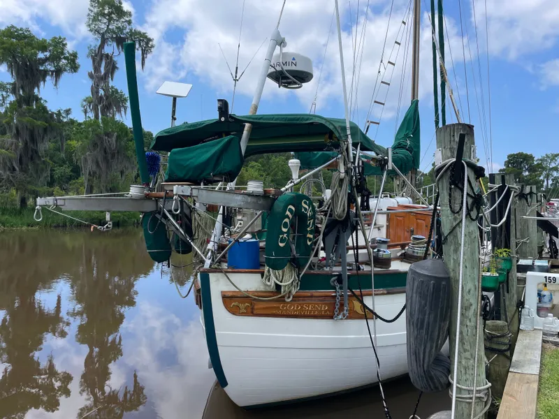 Slide: The Image of 1983 Formosa Spindrift 43 sailboat docked, surrounded by trees. - 1