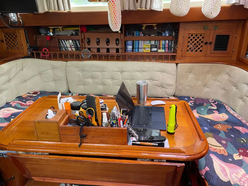 Slide: The Image of Interior of a Formosa Spindrift 43 yacht, with laptop and tools on the table. - 24