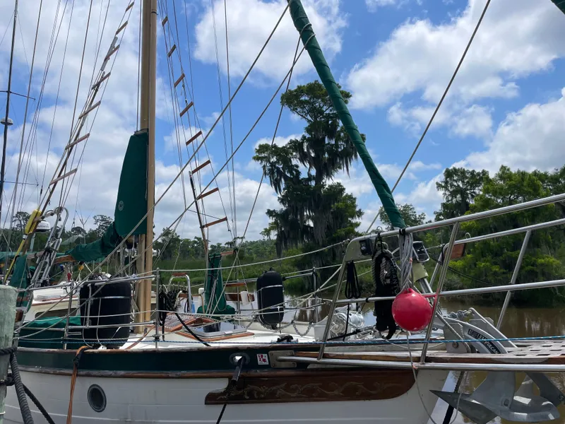 Slide: The Image of 1983 Formosa Spindrift 43 sailboat docked, blue sky background. - 3